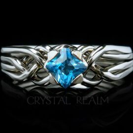 4 piece puzzle ring with princess cut blue topaz and palladium with a medium low setting