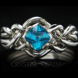 four piece puzzle ring with blue topaz and open weave